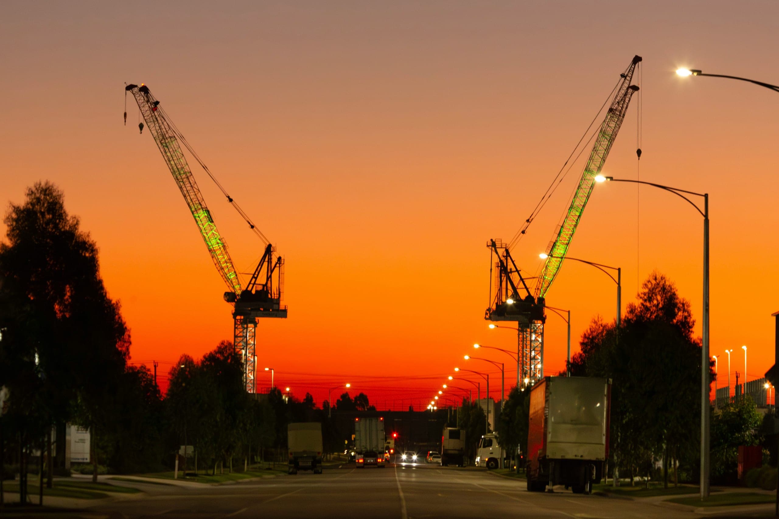 Tower cranes over a construction site at dusk in Kigali, Rwanda